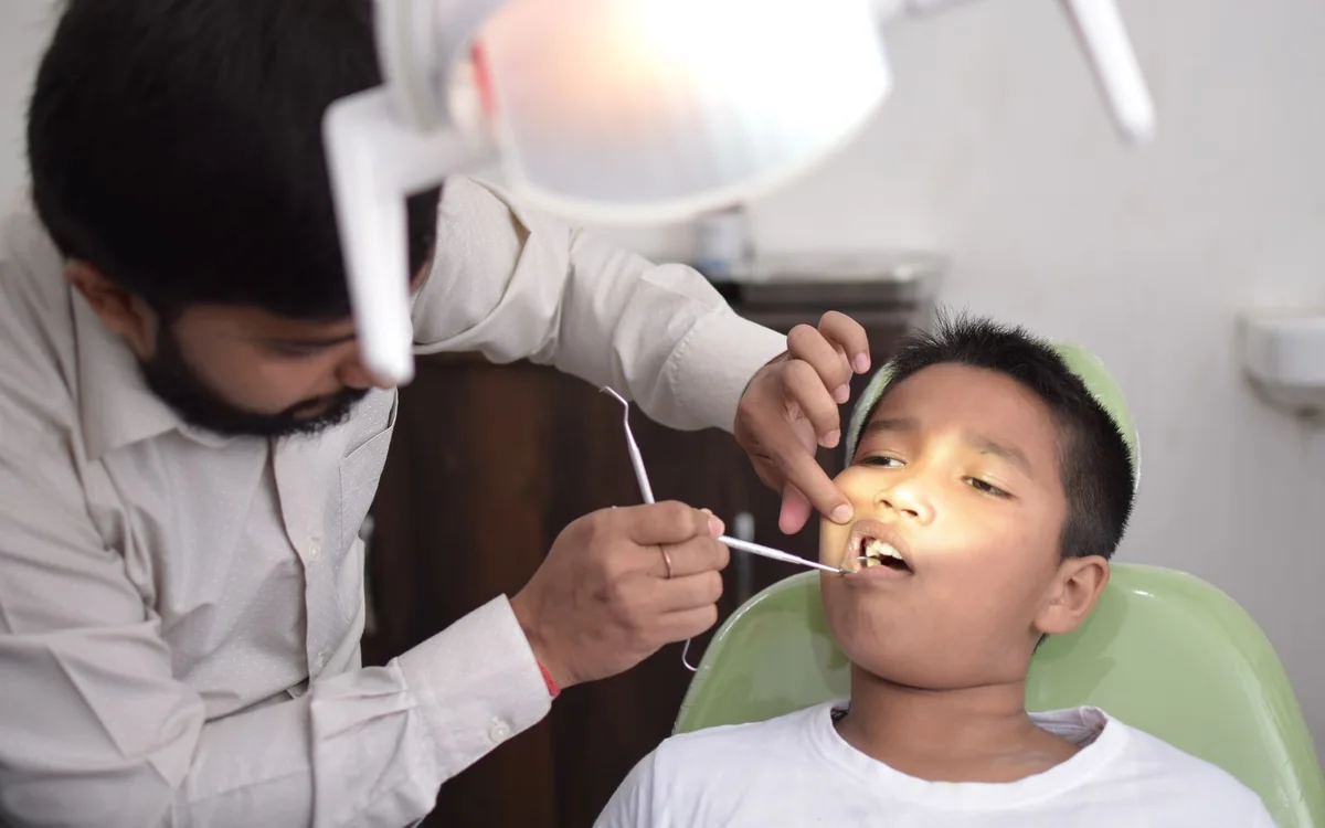 Child receiving a dental check-up in an Indian clinic