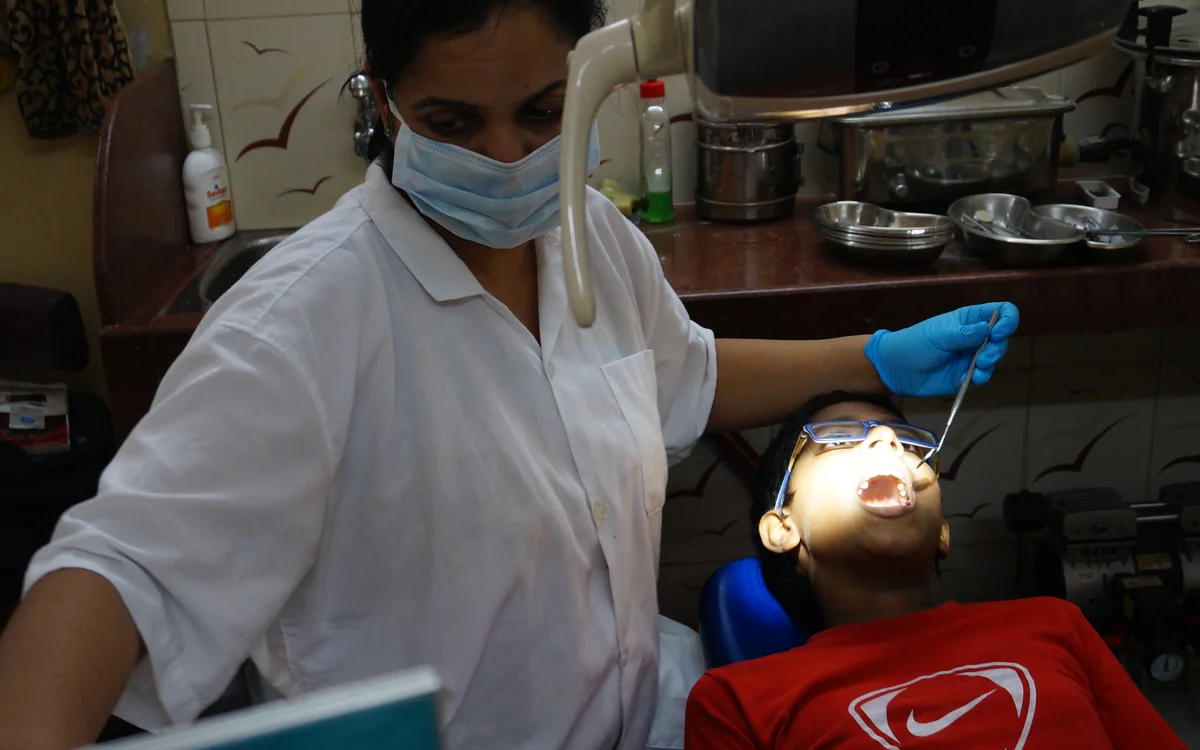 Indian dentist providing focused dental care